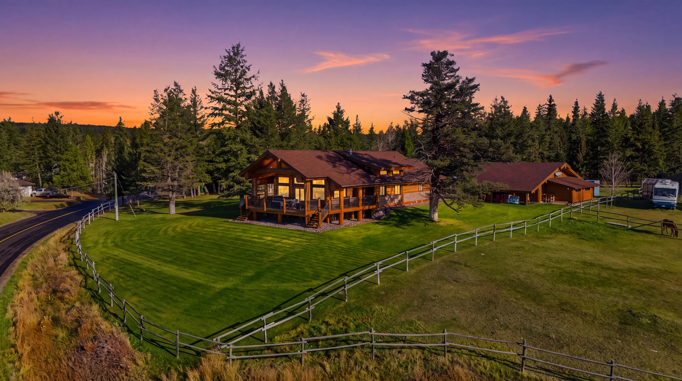 Twilight aerial view of the residence, shop and landscaped grounds